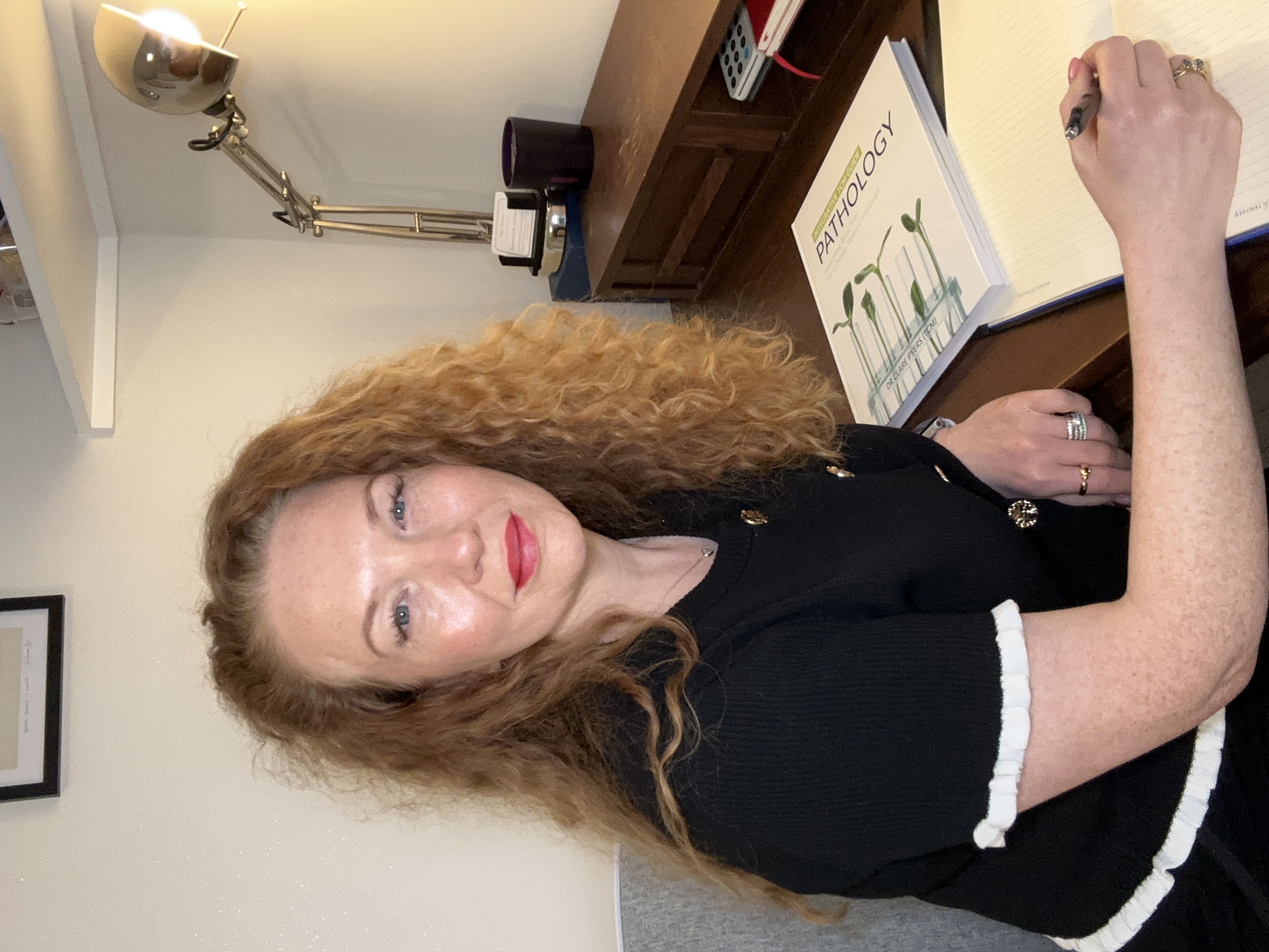 Siân Sayers making notes at her desk